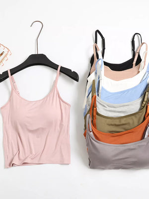 Pink cami with adjustable straps and a stack of camis in various colors including black, white, blue, grey, green, orange