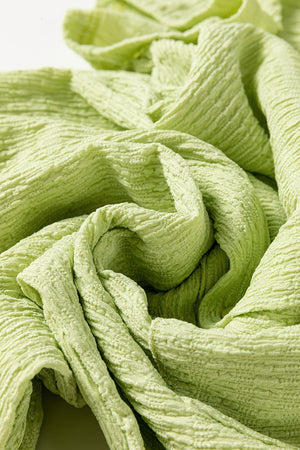 Lime textured collared romper with patch pocket, close-up of fabric detail