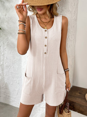 Ribbed knit button-front romper in eggshell with scoop neck, sleeveless, and patch pockets.