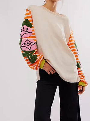 Beige tee with embroidered floral stripe sleeves and green cuffs