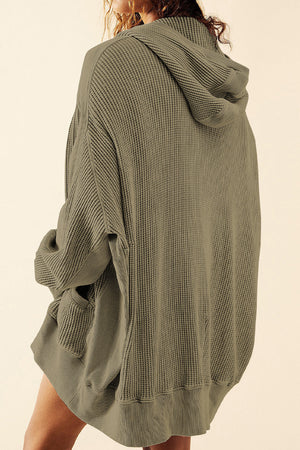 Army green waffle knit hooded zip-through jacket with pockets.