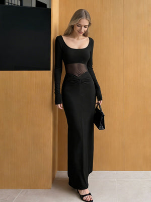 Black long-sleeve maxi dress with sheer mesh inset and knot detail.