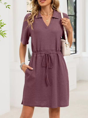 Textured polo dress in pink with adjustable drawstring waist and short sleeves.
