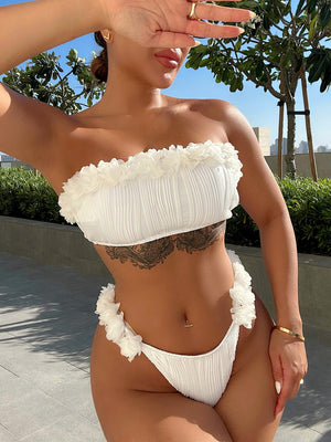 Textured white bandeau bikini set with ruffle trim and ruched fabric.