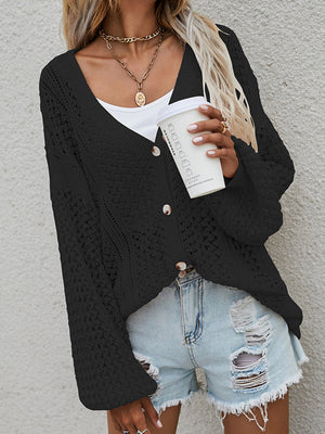 Black open-knit acrylic cardigan with balloon sleeves and button front.