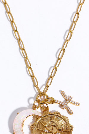 Gold celestial pendant necklace with zodiac symbols and moon charm.