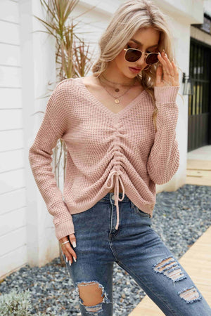 Pink ruched-front waffle knit sweater with V-neck and drawstring detail