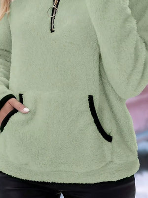 Light green fleece quarter zip pullover with black trim on pocket and zipper.
