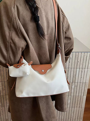 Ivory canvas hobo bag with coin purse and brown leather trim.