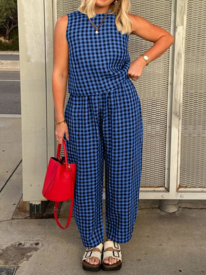 Royal blue gingham cropped tank and tapered trousers set with a red handbag.