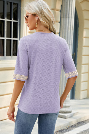 Lavender textured V-neck top with lace trim on sleeves.