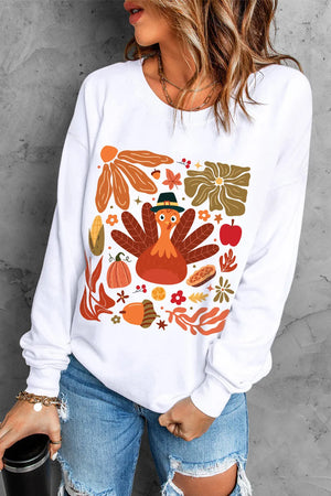 White round neck sweater with a playful Thanksgiving turkey and fall harvest graphic print.