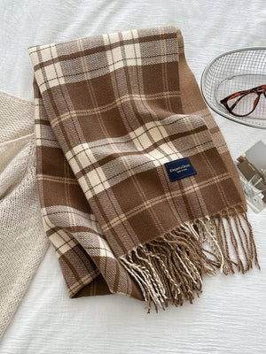 Brown plaid scarf with fringe detail and a cozy feel.