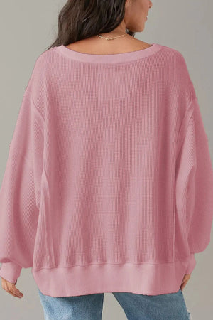 Dusty pink waffle knit pullover sweater with slit sleeves and crew neck.