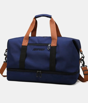 Dark Navy dual-compartment weekender bag with contrast brown and black straps and dual zippers on the bottom compartment.