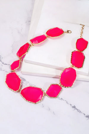 Prismatic resin stone collar necklace in hot pink with gold-tone alloy setting.