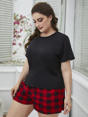 Relaxed black tee with red and black plaid shorts set.
