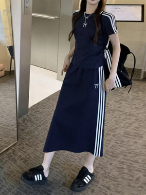 Dark blue striped tee and midi skirt ensemble with bow detail, worn by a woman.