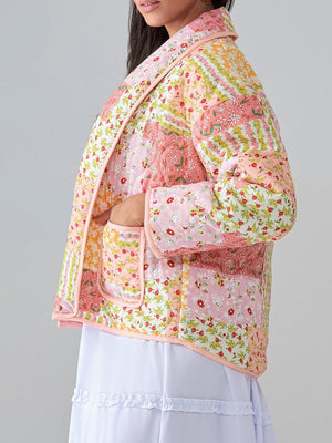 Floral quilted patchwork jacket in pink with pockets and a shawl collar.