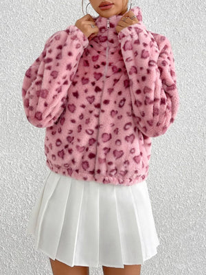 Blush pink faux fur zip track jacket with heart pattern, high neck, and long sleeves.