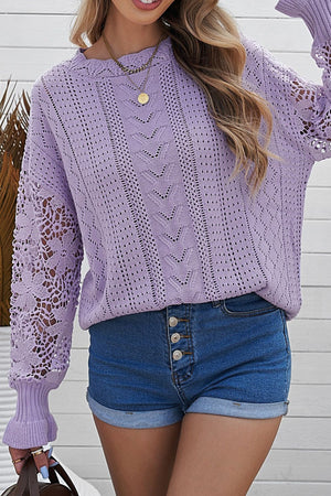 Lavender openwork knit sweater with lace sleeves and detailed stitching.