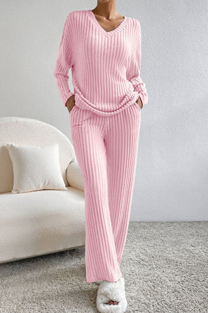 Blush pink ribbed V-neck loungewear set with long sleeves and wide-leg pants.