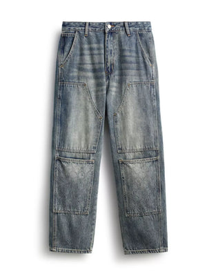 Men's blue straight leg jeans with patchwork and textured pockets.