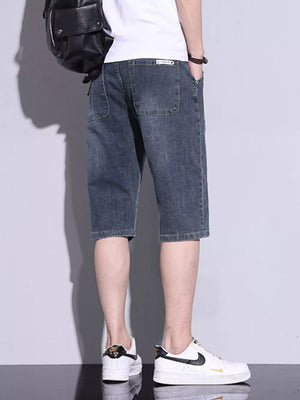 Men's classic washed denim shorts in dusty blue with button closure and patch pockets.