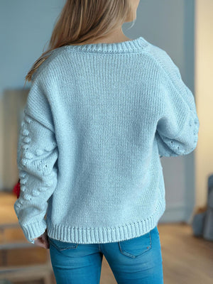 Pastel blue knit cardigan with textured sleeve details