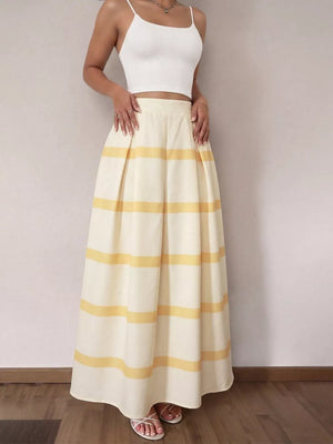 Flowy maxi skirt with yellow horizontal stripes and pockets, styled with a white crop top.