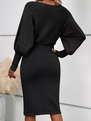 Black acrylic bodycon sweater dress with dramatic lantern sleeves and ribbed details.