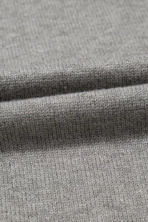 Gray knit top with a subtle ribbed texture, close-up detail.