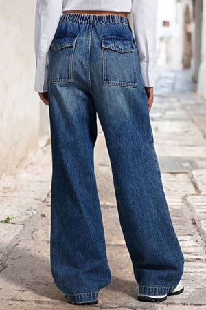 Medium wash denim palazzo jeans with elastic waist and patch pockets.