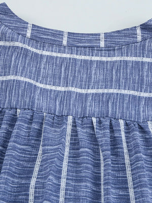 Dusty blue striped V-neck blouse with a buttoned front and gathered waist detail.