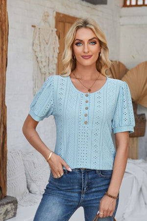 Light blue perforated puff sleeve henley blouse with button detail and round neckline.
