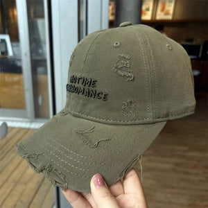 Army green distressed cotton baseball cap with embroidered text and frayed details.