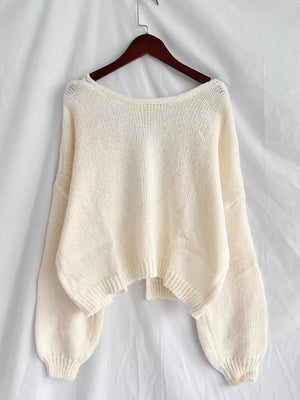 Cream textured knit cardigan with wide neckline and balloon sleeves.