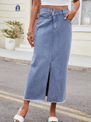 Light denim midi skirt with asymmetric front slit and frayed hem.