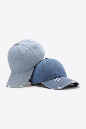 Distressed denim baseball caps in light and medium blue with adjustable strap