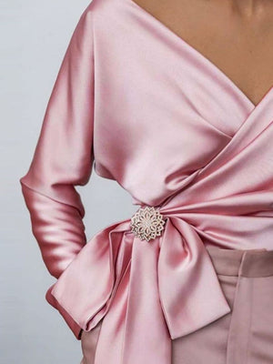 Blush pink satin blouse with draped detail and crystal brooch
