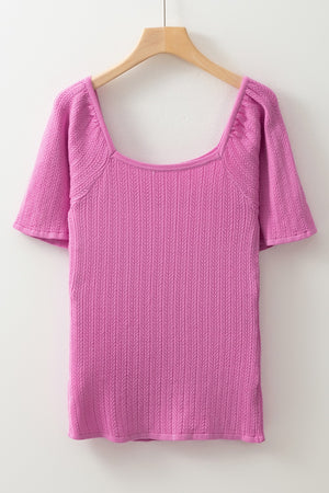 Red-violet knit blouse with square neckline and flutter sleeves, featuring a textured stitch pattern.