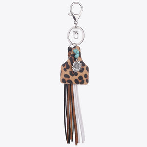 Leopard print tag keychain with flower charm, turquoise bead, and multi-color tassels.