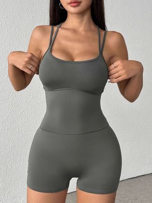 Grey scoop neck active romper with spaghetti straps and short legs, made of cotton blend.