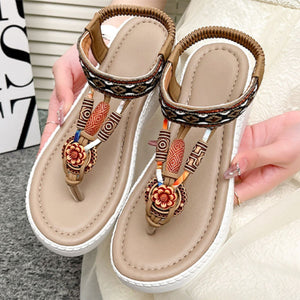Ethnic-patterned wedge sandals in khaki with floral accents and beaded details.