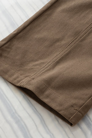 Caramel seamed front wide leg trousers detail showing stitching and fabric texture.