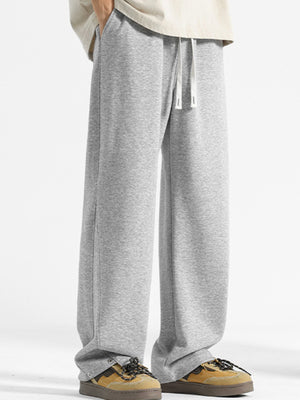 Men's grey drawstring sweatpants with a relaxed fit and snap button ankle detail.