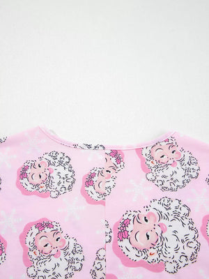 Pink V-neck pajama top with a festive Santa Claus and snowflake print.