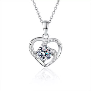 Silver heart pendant necklace with a large round cubic zirconia and small accent stones.