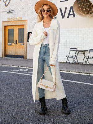 Longline knit collar cardigan in white acrylic with a relaxed fit, worn open over a tank top and jeans.
