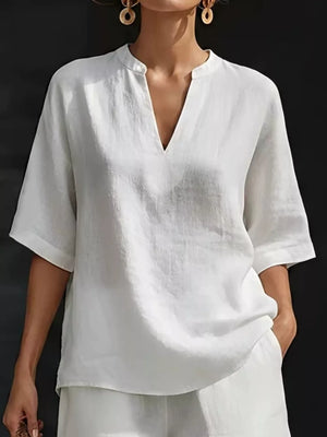 White oversized linen-blend top with V-neck and short sleeves, part of a two-piece set.